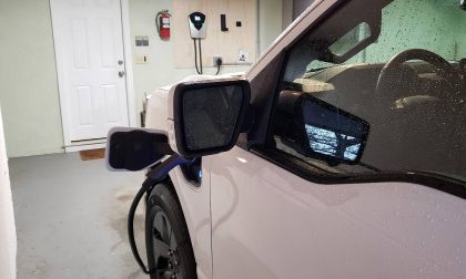 A Ford F-150 Lightning EV pickup charges inside an owner's garage