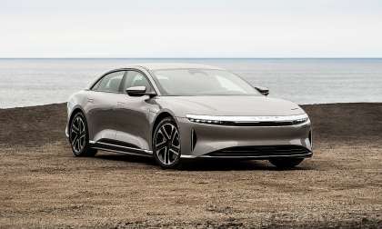 Silver Lucid Air parked near the ocean in a front three-quarter view.