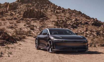 Image showing a grey Lucid Air Grand Touring Performance parked in front of a rocky hill in the desert