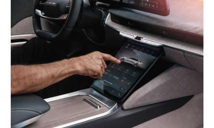 A driver operates the lower touchscreen in a Lucid Air
