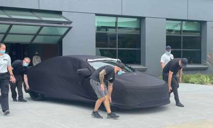 Image showing the Lucid Air Sapphire under a cover as it heads to The Quail for its reveal