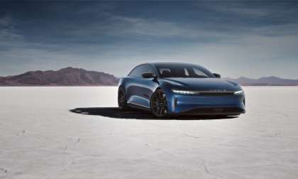 Rendering of the Lucid Air Sapphire parked on a dry lake bed with mountains in the background.
