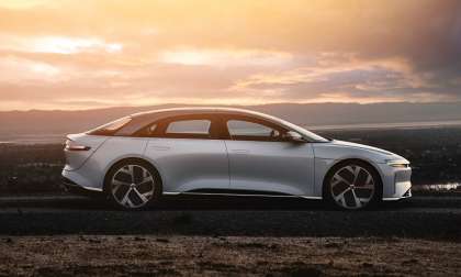 Side profile image of a white Lucid Air at sunset