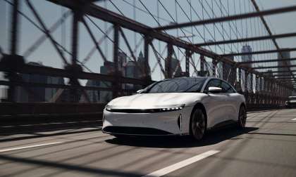 Image showing a white Lucid Air driving across the Brooklyn bridge