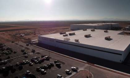 High-angle drone shot of Lucid's AMP-1factory in Casa Grande, Arizona. The factory's buildings feature hard edges and are mostly white to repel solar energy and keep them cool.