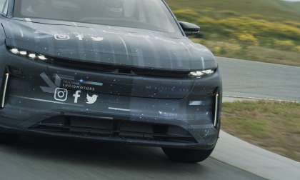 Front image of the Lucid Gravity SUV testing on public roads wearing camouflage.
