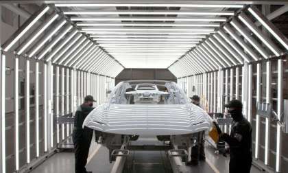 Image showing a Lucid Air passing through a well-lit inspection tunnel at the AMP-1 factory.
