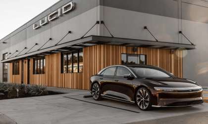 Image showing a dark red Lucid Air parked outside the company's newest Studio location in Millbrae, California