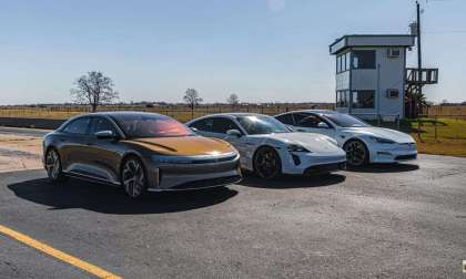 Image showing a gold Lucid Air parked beside a white Porsche Taycan Turbo S and Tesla Model S Plaid as they prepare for a three-wide drag race.