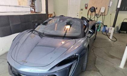 2025 McLaren Artura Spider charges on an Emporia Level 2 EV charger inside a lucky person's garage