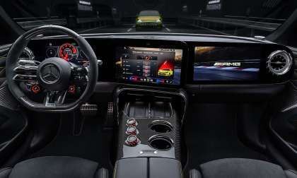 Mercedes-AMG performance cockpit with digital dashboard, AMG drive settings, carbon-fiber console, and sport steering wheel.
