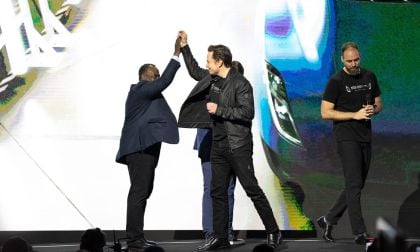 Image of Elon Musk giving high five courtesy of Tesla, Inc.