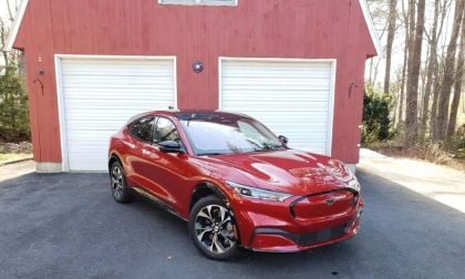 Ford Mustang Mach-E in brilliant red in front of a barn