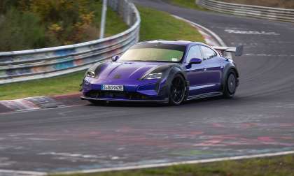 Purple Porsche Taycan Turbo GT with Manthey Kit cornering on the Nürburgring track.