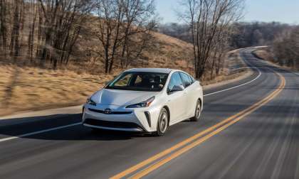 Prius beats which car in a race?