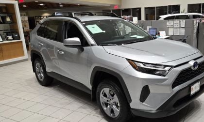 A Toyota RAV4 Hybrid awaits a buyer at a Toyota dealership