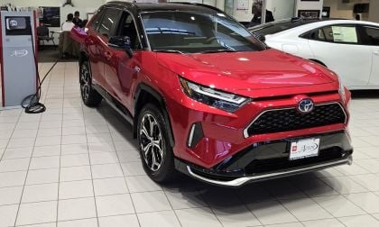 A Toyota RAV4 Plug-In is shown on display in a dealer showroom