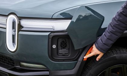 An EV drive points to the charge port of a Rivian R1S