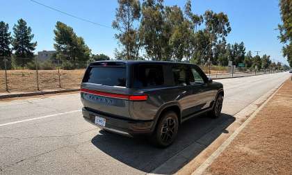 Gray Rivian R2 shown from the rear three-quarter angle on a city street.