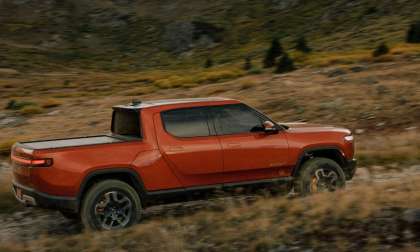 Red Rivian R1T electric pickup driving off road