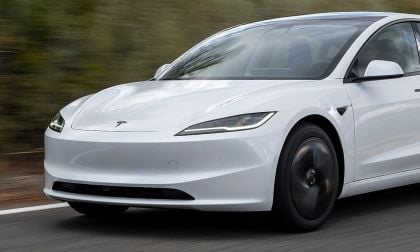 Close-up of Tesla Model 3 front while driving showing motion blur