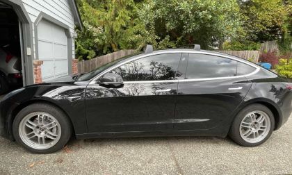Black Tesla model 3 with silver mag wheels