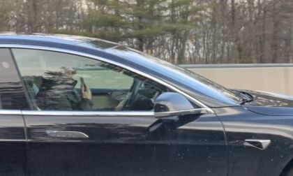 Image of Tesla Model S driver speeding while engaged in distracted driving by John Goreham.