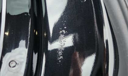 A Tesla Model Y with a paint defect is shown