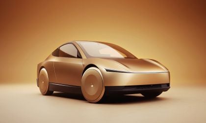 Golden Tesla Cybercab concept car in a minimal studio setting with smooth aerodynamic design