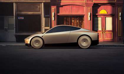 Tesla Cybercab shown in side profile on a city street at golden hour.