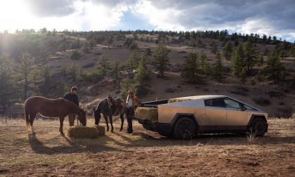 Tesla Cybertruck side profile with stainless steel exterior parked in an open landscape, emphasizing its angular design, electric powertrain, and durable utility build.