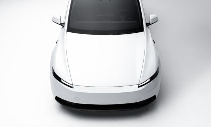 White Tesla Model Y electric SUV front view on a clean minimalist background