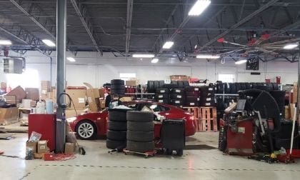 Image of Tesla shop area with piles of tires everywhere by John Goreham