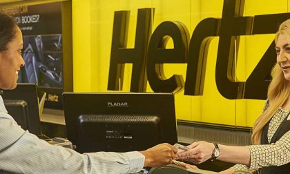 A customer talks to a Hertz sales associate