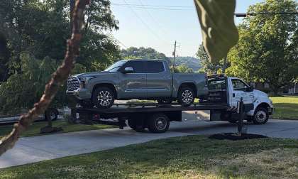 Tiffany’s 2024 Toyota Tundra being loaded onto a flatbed tow truck after experiencing an engine failure at 30,000 miles.
