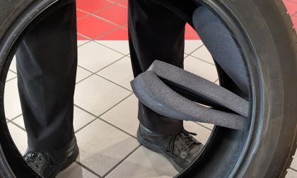 Acoustic foam falling out of a defective tire on tiled floor of a tire shop.