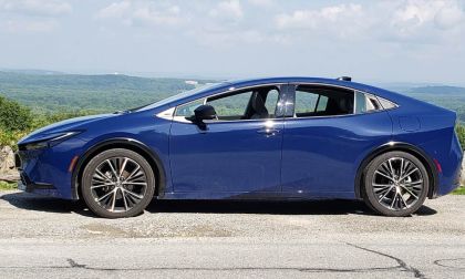 A Toyota Prius looks handsome in blue against a sky background
