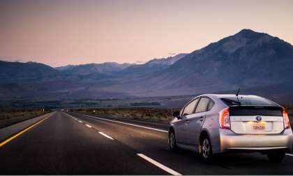 2012 Toyota Prius Silver driving as dusk on the highway