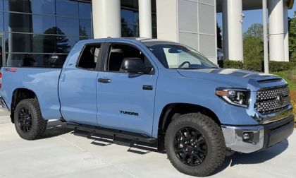 Toyota Tundra cavalry blue truck parked in front of a Toyota dealership