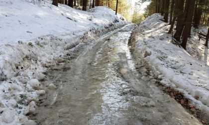 A rural road is shown covered in a foot of ice