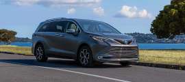 Gray 2025 Toyota Sienna Platinum parked near the waterfront in a front three-quarter view.