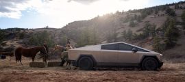 Tesla Cybertruck parked on a rural ranch beside horses, showing stainless steel side profile