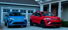 2027 Chevrolet Bolt EV, two of them, blue and red, parked in front of house