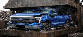 Blue Ford F-150 Lightning in a car crusher