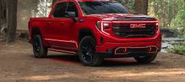A 2026 Red GMC Sierra with custom headlights.