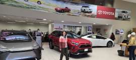 A shopper looks for good deals in a Toyota showroom