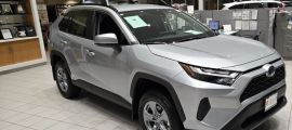A Toyota RAV4 Hybrid awaits a buyer at a Toyota dealership