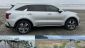 Silver Kia Sorento PHEV on the beach and people by the water on Oregon shore