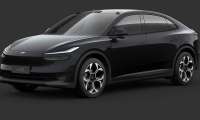A sleek, black Onvo L60 electric SUV shown in a studio setting against a dark grey background.