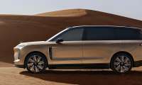 Elegant NIO ES9 SUV parked in sand.
